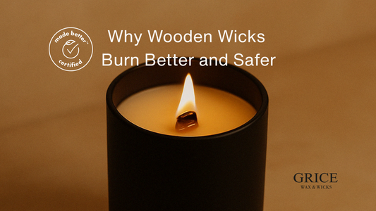 Lit wooden wick candle in matte black vessel — clean burn, warm flame, safe for indoor air