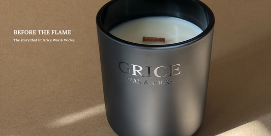 Lit candle in a matte black jar with a soft flame, surrounded by ritual tools. Text overlay reads “Before the Flame – The story that lit Grice Wax & Wicks.
