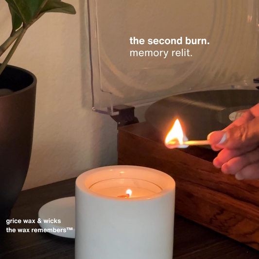 Lit marble candle with refill burning beside a spinning vinyl record. Captures the ritual of the second burn—where scent, memory, and sound merge in a quiet storytelling moment.