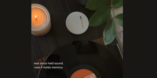Wax and vinyl flatlay with luxury candle burning — poetic storytelling on how wax once held sound, inspired by Grice Wax & Wicks’ memory-driven candles.