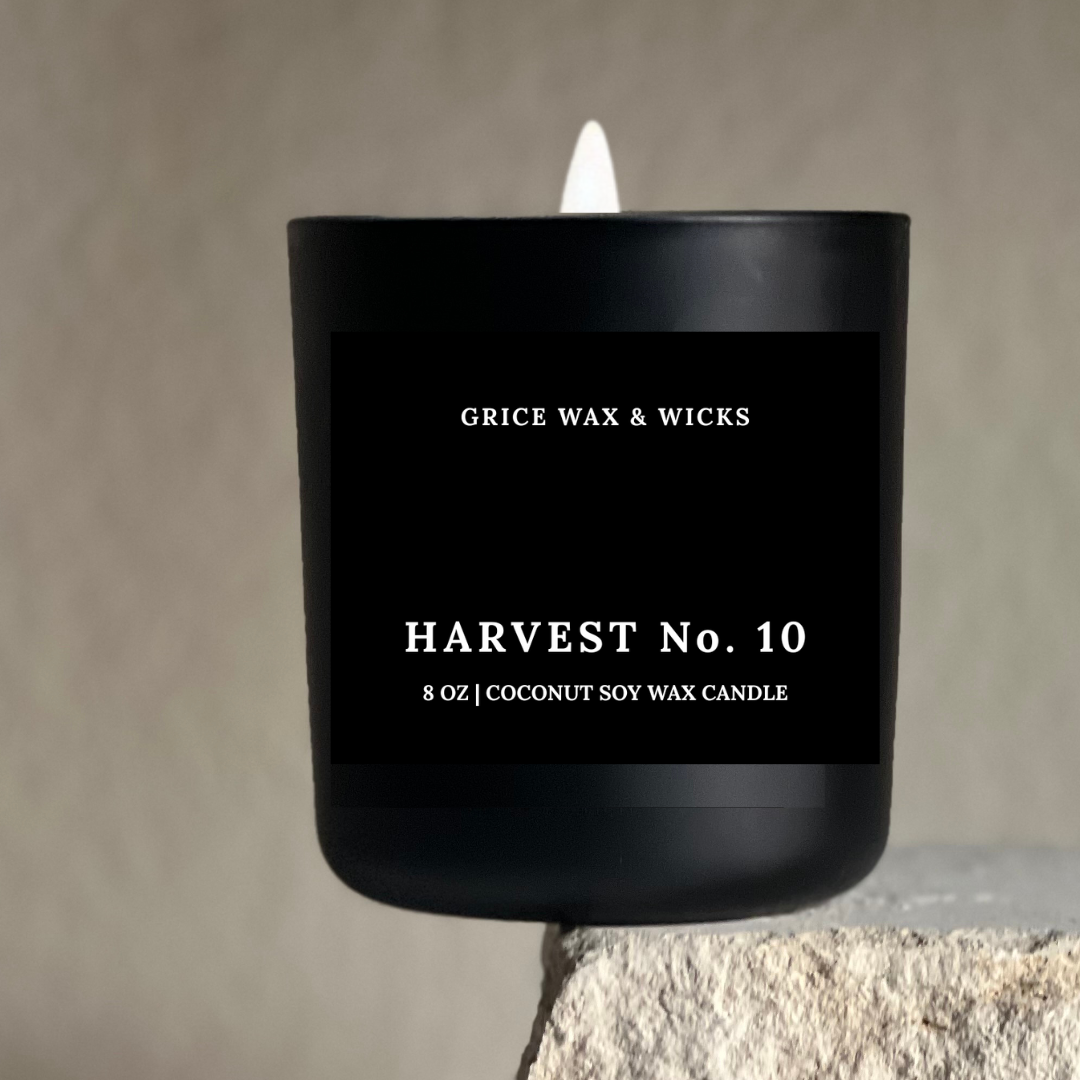Black candle with 'Grice Wax & Wicks' branding on a neutral background