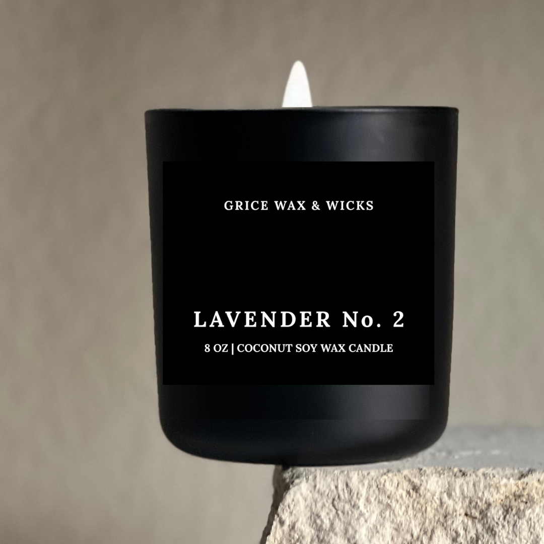 Black candle labeled 'Grice Wax & Wicks Lavender No. 2' on a neutral background