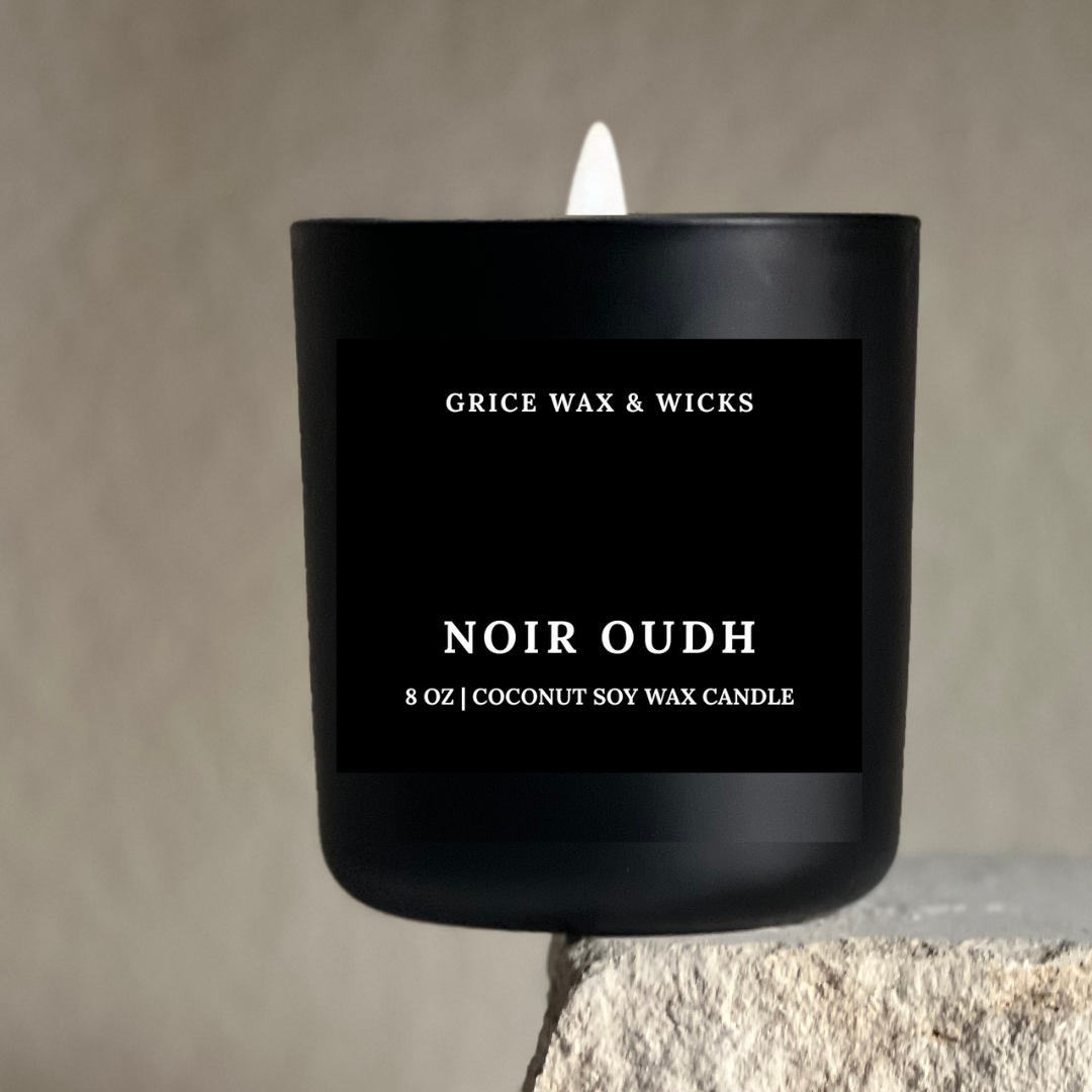 Black candle with 'Grice Wax & Wicks' branding on a neutral background