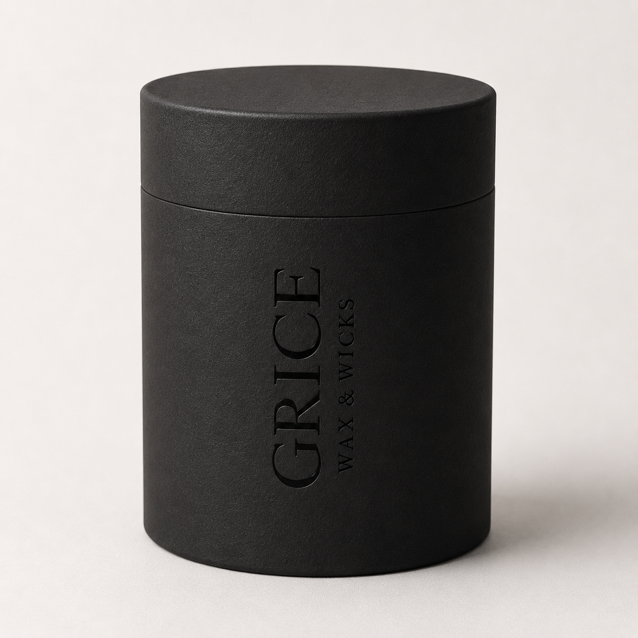 Black cylindrical container with 'Grice Wax & Wicks' branding on a light background