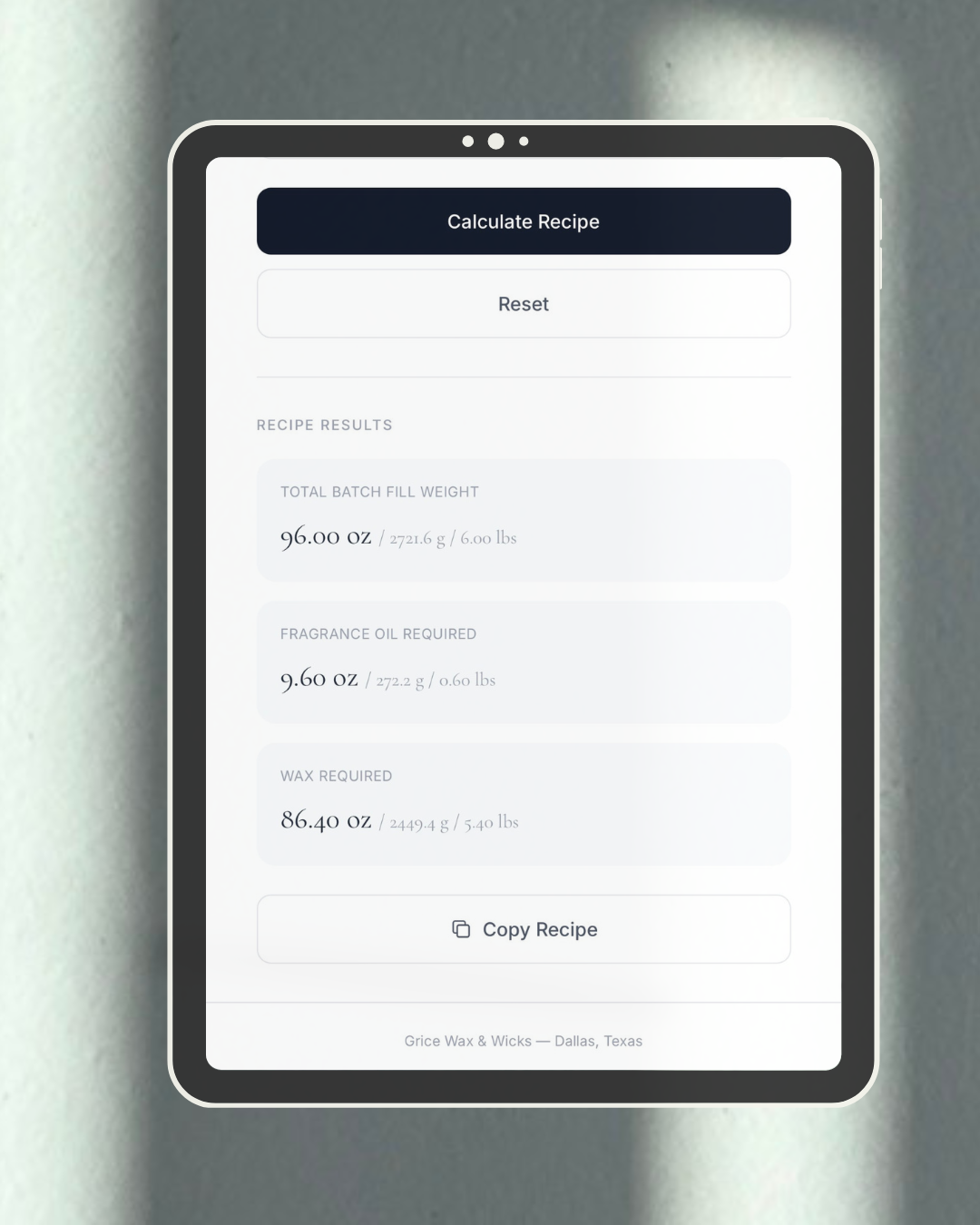 Tablet displaying a batch calculation app on a gray background by grice wax & wicks