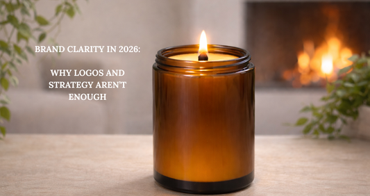 Lit amber candle on a neutral background representing intentional brand clarity and thoughtful systems in 2026.