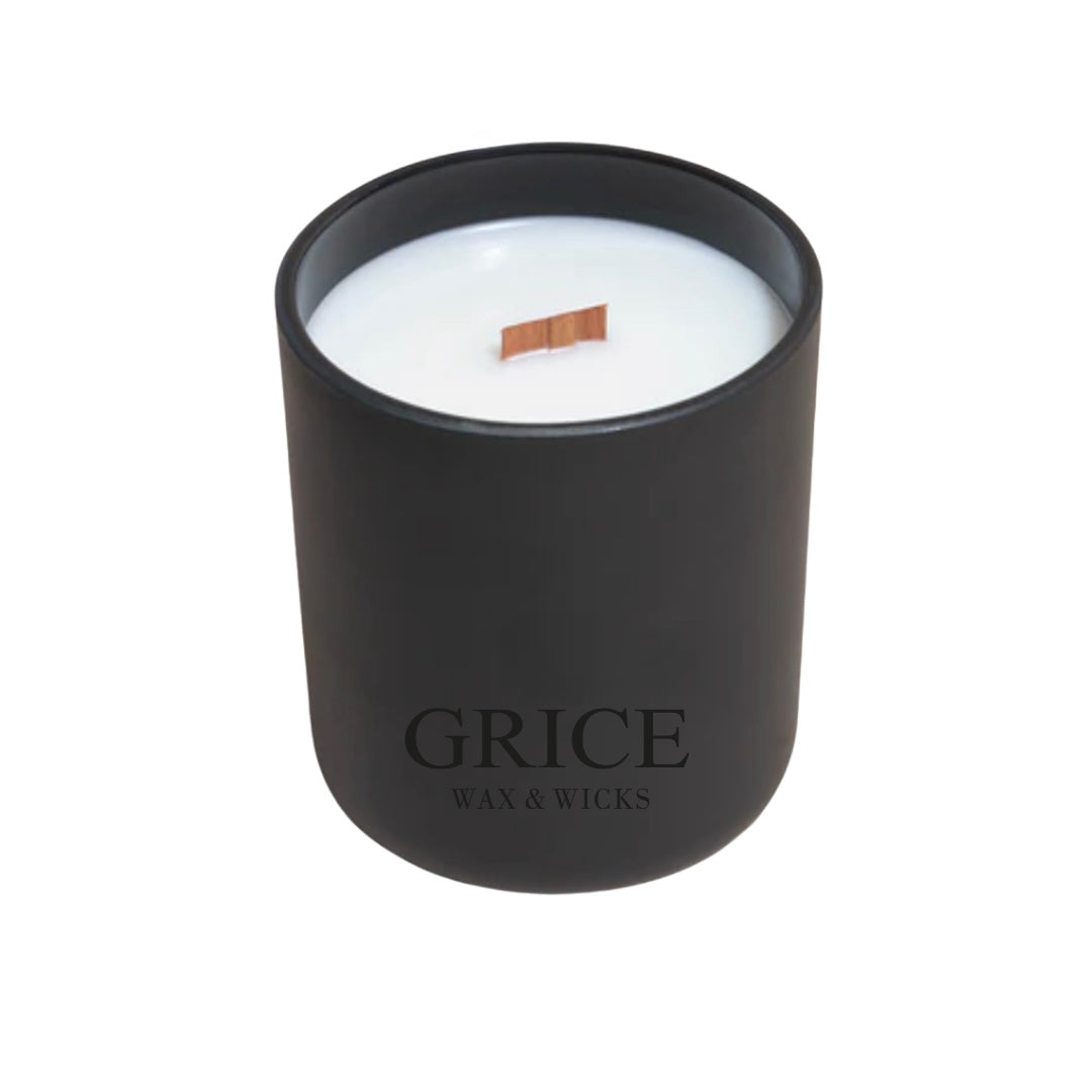 Hand-poured coconut soy candle in a black matte jar with wooden wick by GRICE Wax & Wicks.