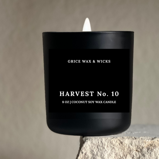 Black candle with 'Grice Wax & Wicks' branding on a neutral background
