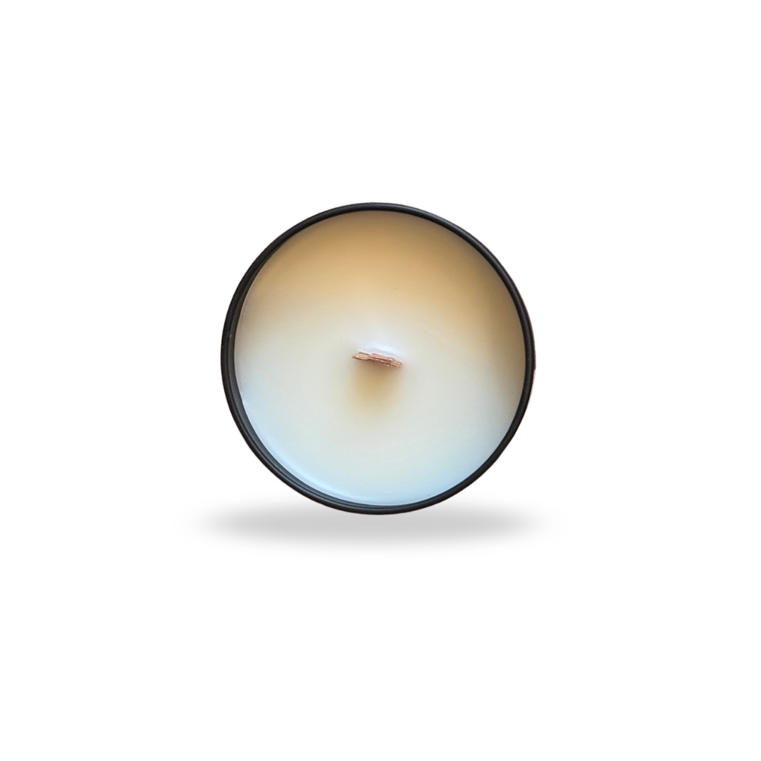 Round candle with a visible wick on a white background