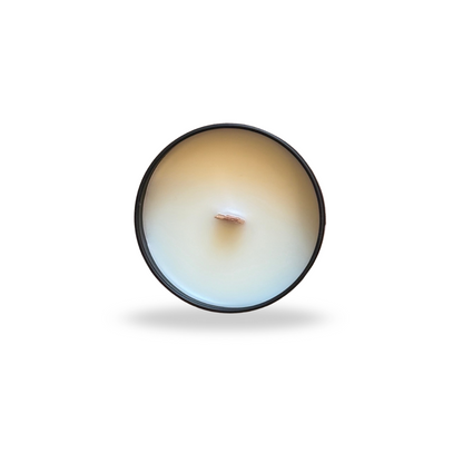 Round candle with a visible wick on a white background