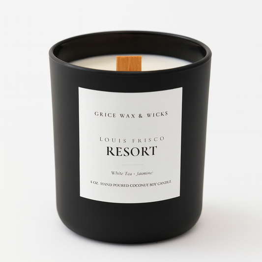 Black candle with a white label on a white background. LOUIS FRISCO RESORT scented candle
