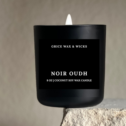 Black candle with 'Grice Wax & Wicks' branding on a neutral background
