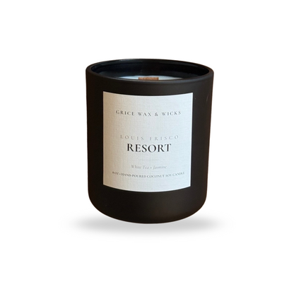 Black candle labeled ‘LOUIS FRISCO RESORT’ by Grice Wax & Wicks — a clean, spa home scent with citrus and soft floral notes — on a white background