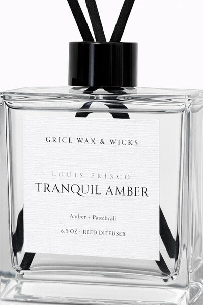 Reed diffuser labeled 'Tranquil Amber' by Grice Wax & Wicks on a white background