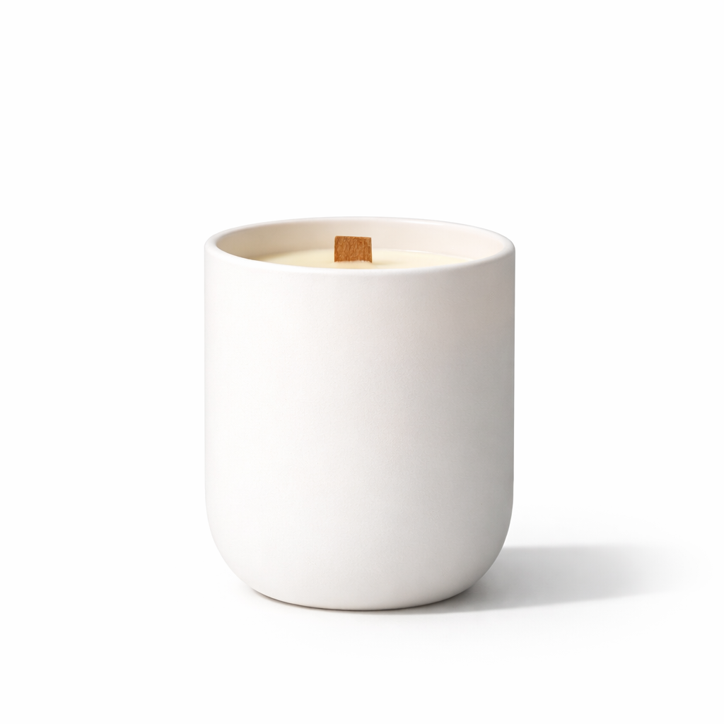 White ceramic candle holder with a wooden wick on a white background