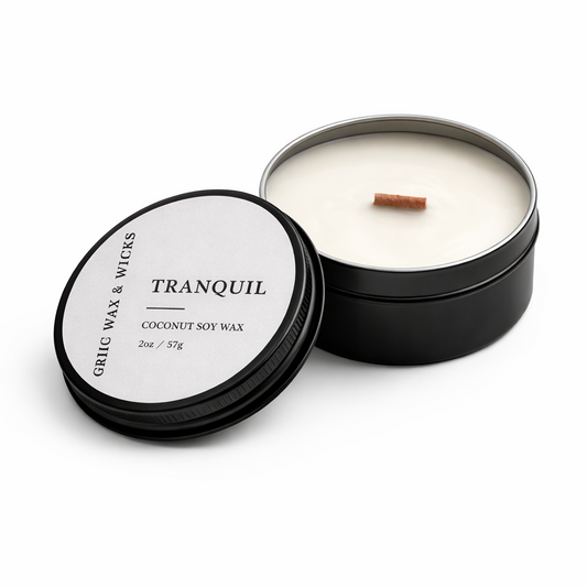 Candle in a black tin labeled 'Tranquil' on a white background