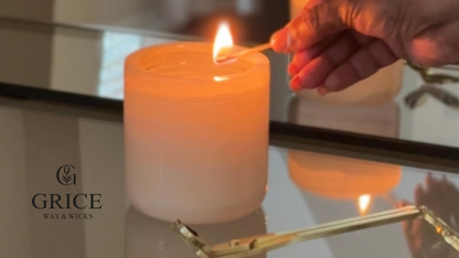 Person lighting a candle with 'Grice Wax & Wicks' branding.