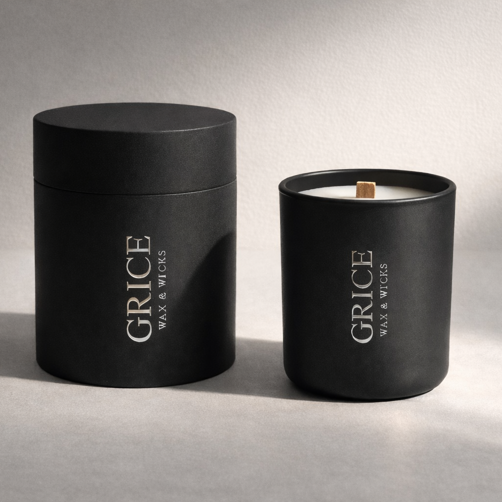 Black candle and container with 'Grice Wax & Wicks' branding on a gray background