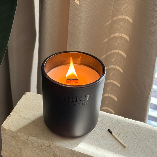 Warm Whispers scented candle, by Grice Wax & Wicks. Black Matte Jar with wood wick flame. Clean Home Fragrance. 