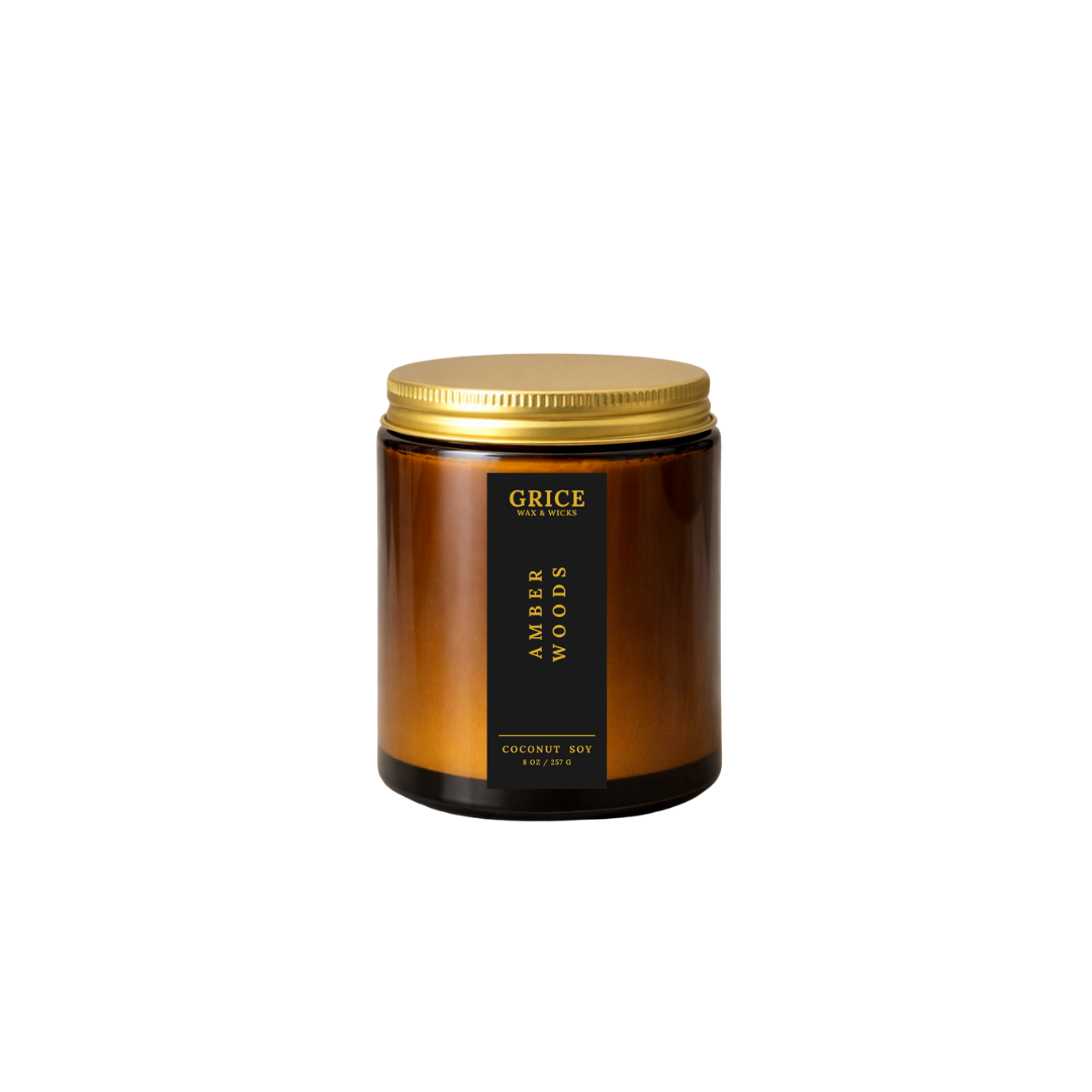 Candle jar with gold lid and black label on a white background