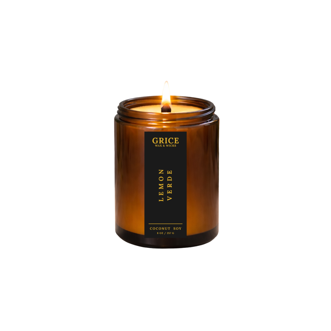 Candle in an amber jar with a black label on a white background