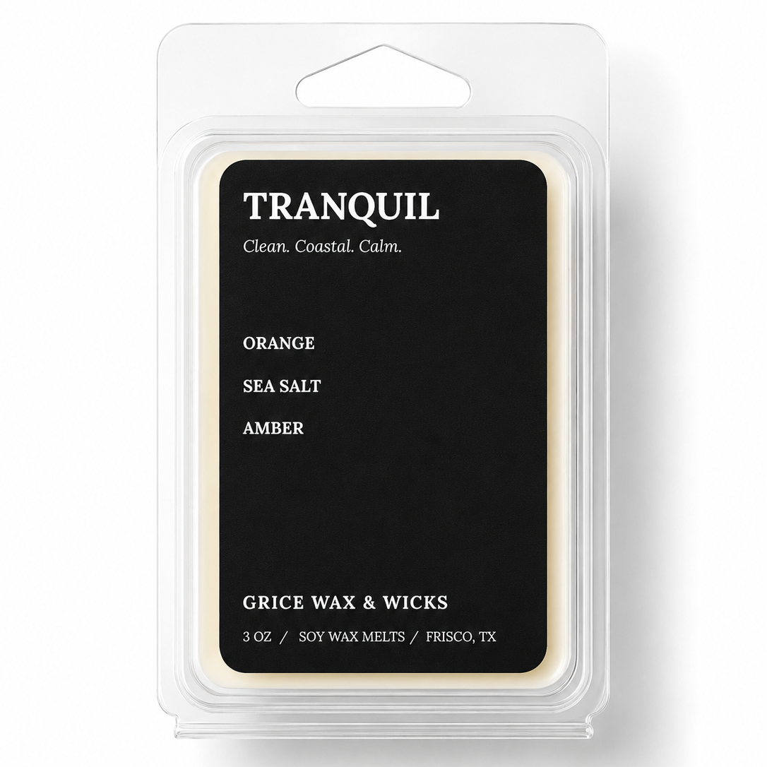 A 3 oz package of Tranquil Scents soy wax melts in the Orange Sea Salt Amber scent, featuring a black label with white text inside a clear plastic clamshell container.